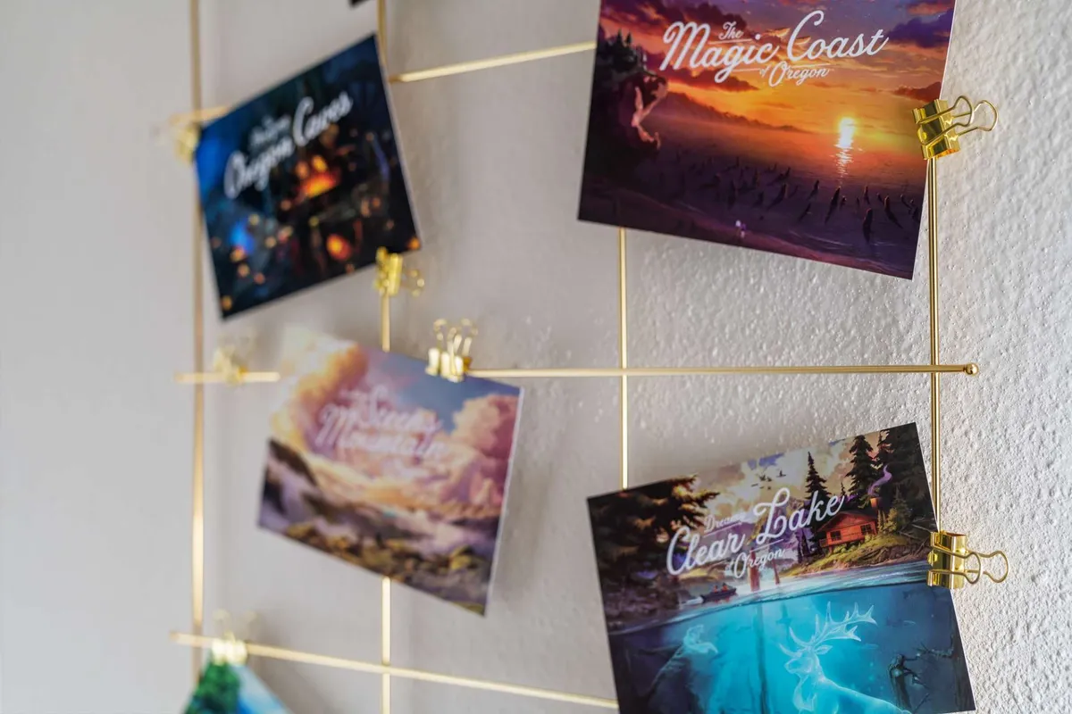 A golden grid structure displays a collection of postcards from various destinations, evoking the spirit of travel and exploration. The setup hints at journeys taken and places yet to be discovered, all within a bright, artful corner of the home.